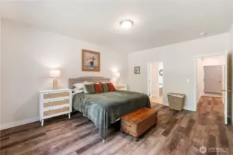 The primary bedroom is at the opposite end from the guest bedrooms. The window looks out to the back yard.
