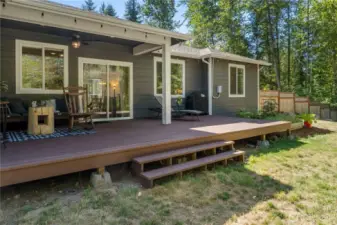 Covered patio allows you to enjoy the outdoors, rain or shine! Garden beds to the right of the porch, too.