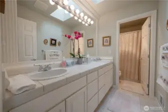 The upstairs full bath offers plenty of storage with double sink vanity.