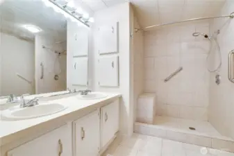 Attached is a spacious 4-piece bath with dual vanities and ample cabinet storage.