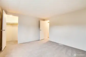 Another view shows the walk-in closet—freshly painted like all closets in the home. So much storage throughout!