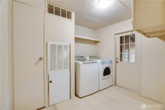 The functional utility room includes washer/dryer and even more storage, with a door leading to the carport.