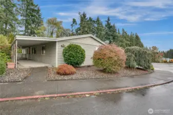 Attractive landscaping and wide sidewalks make this neighborhood perfect for pleasant strolls. The covered porch sits to the left of the home.