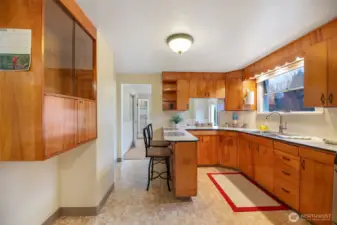 Generous kitchen looking towards the dining room.  Pass through window makes service a breeze.