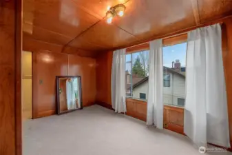 Upper bedroom with timeless wood décor. Large picture window allows for plenty or light in the daytime. Two closet spaces for you to enjoy.