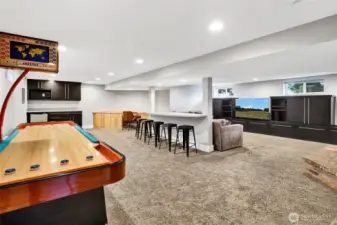 Quite possibly the favorite spot in the entire home is the basement! Enjoy shuffleboard, a dry bar, desk space, and a spacious media room for fun and relaxation.