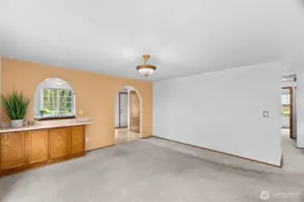 Dining room view towards arched entry to kitchen.