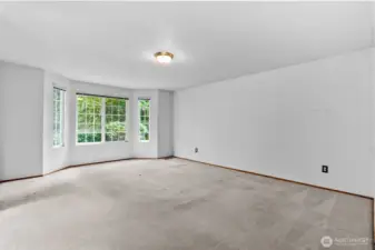 Primary bedroom has ample space for a king sized bed with nightstands.
