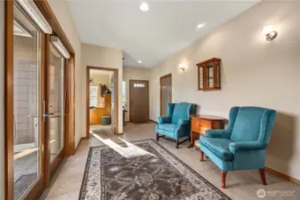 Entry seating looking and fenced side yard and patio.