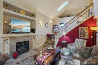 Living room with open staircase up stairs.