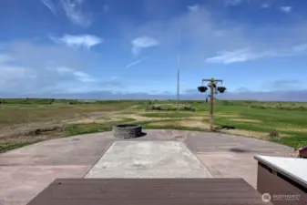 View from the oceanfront deck including the patio, firepit and short walk to the beach.