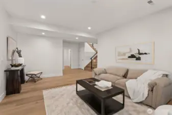 Lower level living room. Laundry room next to stairs.