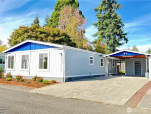 New exterior paint, fresh landscaping with young and mature plants.