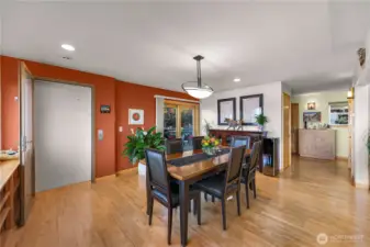 Expansive dining area with plenty of room for gatherings and entertaining, leads to large patio through sliding door and access to elevator