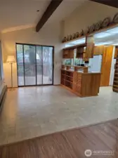 Living room looking into dining and kitchen area, with sliding doors out to covered deck.