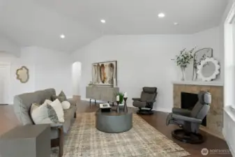 Another view of the living area, the arched doorway in the back leads to the primary bedroom, the 2nd bedroom and laundry room with access to the garage.