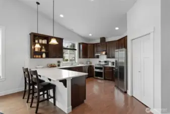 The generous kitchen offers a breakfast bar, pantry, all stainless steel appliances and abundant cupboard and counter space.