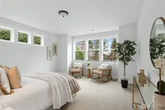 The bright primary bedroom also enjoys views over the bay.