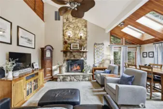 Another view of the living/dining spaces with the stunning river rock electric fireplace for those chilly winter evenings.