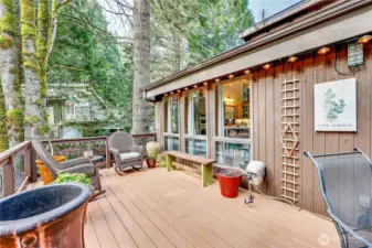 Another view of the back deck accessible from the dining area. Note the wonderful wall of windows that light up the updated kitchen.