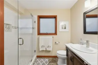 The updated main floor 3/4 bath with a step-in shower.