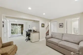 A view from the family room looking towards the back deck off the lower level. Note the area currently used as craft room. What would you love to do with this addition living space?