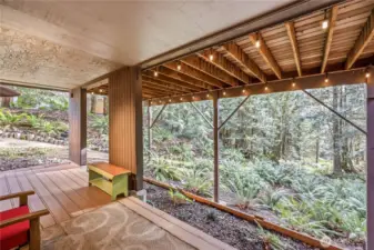 Another view of the lower level deck and the beautifully naturalized setting.