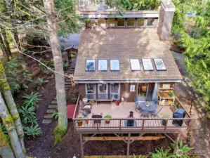 An aerial view of the home, the upper deck, and the site.