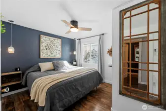 Comfortable primary bedroom featuring a walk-in closet and private half bath.
