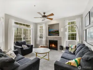 Large windows and a sliding door brighten the living room with natural light.