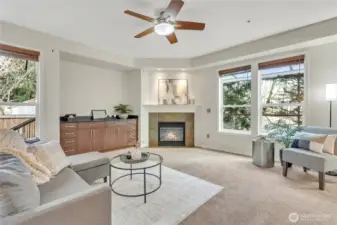 Spacious family room featuring built-in theater cabinet storage and a cozy gas fireplace, perfect for relaxing or entertaining.