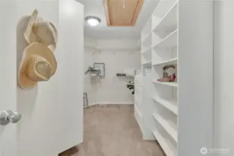 Spacious walk-in closet equipped with built-in organization, offering practical storage solutions with effortless style.