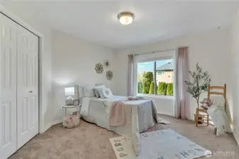 One of five bedrooms, including the primary, on the second floor, this room features a cozy touch with built-in closet organization for added functionality.