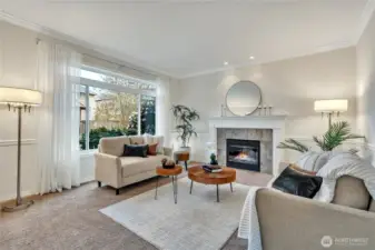 Elegant formal living room featuring one of the home's three cozy gas fireplaces, perfect for relaxation and entertaining