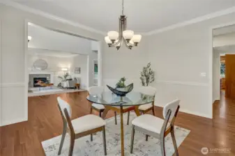 Spacious formal dining room showcasing beautiful hardwood floors. Butler's pantry conveniently located through the doorway to the right.
