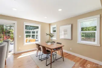 Enjoy casual meals or morning coffee in this bright breakfast nook framed by windows and garden views.