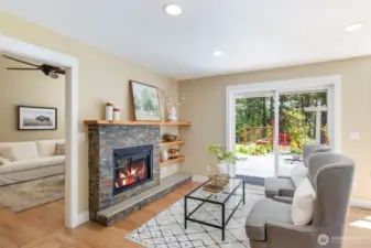 Cozy up by the propane fireplace in this inviting family room, filled with natural light and peaceful garden views.