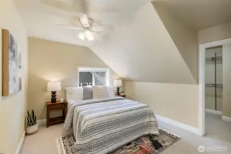 Charming upstairs bedroom offers comfort, light, and a serene view of the surrounding landscape.