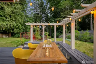 Savor summer evenings on the custom-crafted deck with a modern pergola and built-in seating—perfect for dining al fresco.