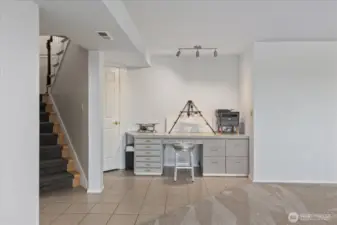 Built in desk area and lots of storage under the stairwell.