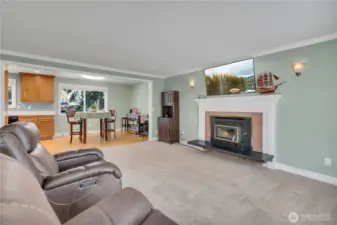 Bright and cheery living room with a wood burning fireplace insert.