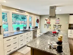 Lots of counter tops and cabinets make this kitchen a cooks dream.  Lovely views of rear yard from large windows.