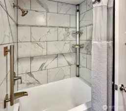 Extra deep soaking tub with gorgeous tile surround and shower.