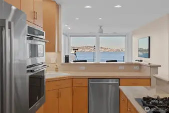 Imagine a top-notch kitchen where every detail shines. You’re preparing a special dinner as friends sit at the counter, enjoying the show while sipping wine. The space is light, bright, and open, with sweeping views that make the room feel endless. Every element invites connection, conversation, and delight.