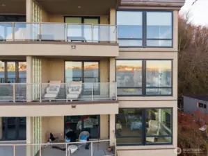 This end-unit condo offers sweeping east-to-west views, showcasing the dazzling night lights of Seattle in the foreground.