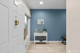 This end-unit condo has a welcoming entry with a gleaming stone floor.