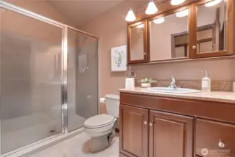 Hall bath serving the three upstairs bedrooms, with full-size shower, generous vanity storage, and room to easily freshen finishes down the road if desired.