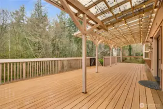 Expansive covered deck with treetop views and tons of space for grilling, lounging, and long summer dinners outdoors.