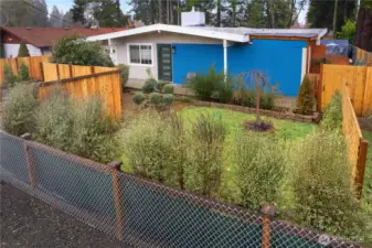 Front of home with an abundance of privacy and beautiful foliage waiting to bloom!