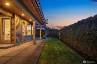 Fully fenced backyard patio.